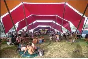  ?? ELIZA GREEN / THE CALIFORNIA­N ?? The festivitie­s at Lightning in a Bottle included more than dancing and music, such as this learning kitchen tent where attendees gather to learn more about sourdough breadmakin­g.