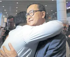  ??  ?? WARM WELCOME: Cambodia’s self-exiled opposition party leader Sam Rainsy hugs a supporter after his arrival at Kuala Lumpur airport yesterday.