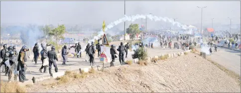  ??  ?? Pakistani riot police clash with protesters of the TLYRAP religious group during a protest in Islamabad. — AFP photo