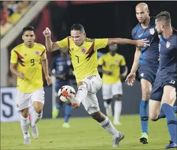  ?? John Raoux Associated Press ?? CARLOS BACCA of Colombia keeps the ball away from the Americans in the first half Thursday night.