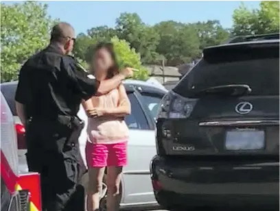  ??  ?? This is a screen grab from a Facebook video that shows a Vancouver police officer lecturing a mother about leaving two children inside a locked car on a hot day. The woman’s face and visible licence plates have been deliberate­ly blurred.