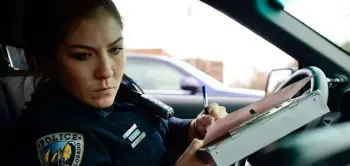  ?? Matthew Jonas, Daily Camera ?? University of Colorado police Officer Cassandra Yuma looks over informatio­n while writing tickets to the driver of a vehicle Wednesday.