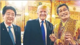  ?? REUTERS ?? US President Donald Trump and Japanese Prime Minister Shinzo Abe pose with Jpop star Pikotaro, famous for the viral Applepen song, during an official dinner at Akasaka Palace in Tokyo.