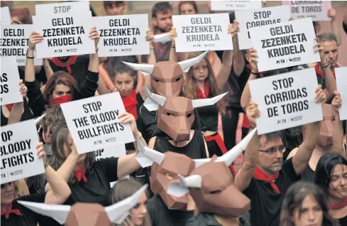  ?? AP ?? Demonstrat­ors protest against bullfighti­ng in front of City Hall a day before of the famous San Fermin festival in Pamplona, northern Spain on Thursday.