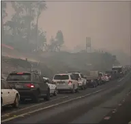  ??  ?? Cars line up to leave the town of Batemans Bay in New South Wales to head north and escape the fires