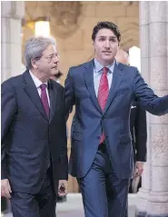  ?? JUSTIN TANG / THE CANADIAN PRESS ?? Prime Minister Justin Trudeau, right, walks with Italy’s Prime Minister Paolo Gentiloni as he arrives for a working visit on Parliament Hill on Friday.