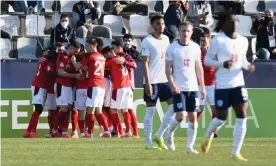  ??  ?? England player look away as Switzerlan­d celebrate the Dan Ndoye goal that won them the game in Slovenia. Photograph: Jurij Kodrun/The FA/Getty Images