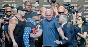  ?? AFP ?? Floyd Mayweather Jr. (left) and Conor McGregor will wear eight-ounce gloves rather than 10-ounce ones for their August 26 fight in Las Vegas. —