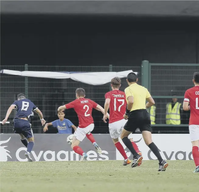  ??  ?? 0 Celtic youngster Michael Johnston fires the ball past England U21 goalkeeper Freddy Woodman to give Scotland U21 the lead in last night’s Toulon Tournament semi-final although the English youngsters fought back to win 3-1.