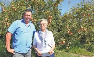  ?? PHOTOS: GLENNEIS KRIEL ?? Kitty du Plessis (right) and her son, Mario, in front of one of their oldest orchards, comprised of Forelle pear trees, on their farm, Aurora. Mario joined his parents on the farm in 2012. ABOVE: