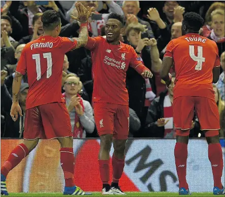  ?? — GETTY IMAGES ?? Liverpool’s striker Daniel Sturridge, centre, celebrates after scoring his team’s second goal during the UEFA Europa League semifinal against Villarreal in Liverpool Thursday.