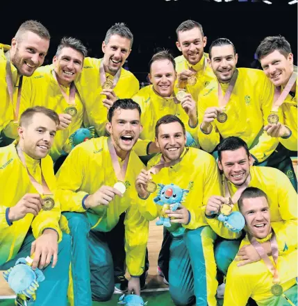  ??  ?? SHINING BRIGHT: The Australian team celebrates after winning gold in the men’s basketball final against Canada.