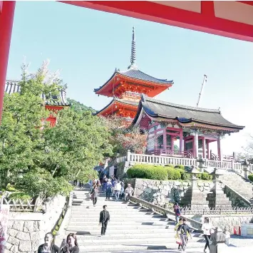  ??  ?? THE SAI-MON (West Gate, also known as a holy place for Nissokan, a meditation method of visualizin­g the Pure Land while viewing the setting sun) & the Sanju-no To (three-storey Pagoda) seen from the Nio-Mon.