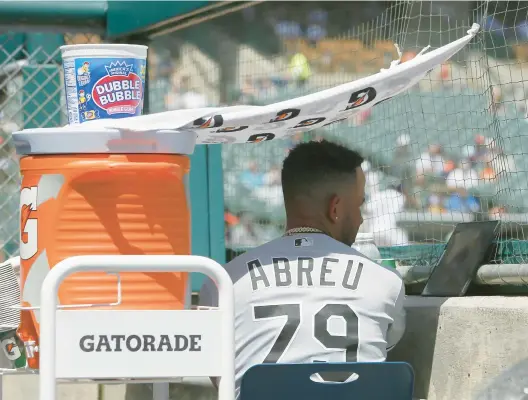  ?? DUANE BURLESON/GETTY PHOTOS ?? Jose Abreu sits under a shaded area he created to watch the game against the Detroit Tigers during the fifth inning at Comerica Park on Wednesday.