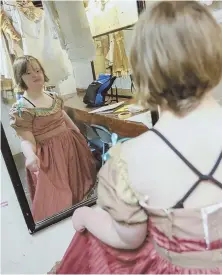  ??  ?? ON WITH THE SHOW: Alice Hawley checks her costume backstage, above, then goes over the party scene of ‘The Nutcracker’ with artistic director Maryann Kodzis at rehearsal, top.