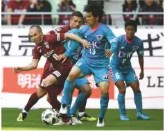  ??  ?? Struggle...Andres Iniesta (left) in action for Vissel Kobe against Sagan Tosu