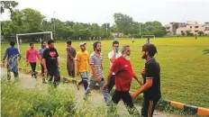  ?? Reuters ?? People walk in a park in Lahore. The government of Punjab has reopened parks in the province.