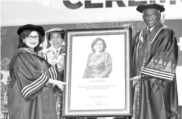  ??  ?? Rafidah Aziz (left) receiving her honorary Doctor of Philosophy in Business Administra­tion from Cyberjaya University College of Medical Sciences Pro-Chancellor Tan Sri Dr R. Palan yesterday. - Bernama photo