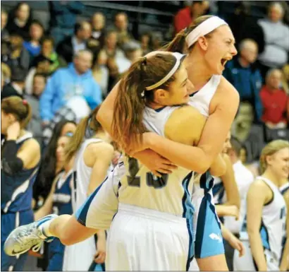  ?? BARRY TAGLIEBER/FOR THE REPORTER ?? NORTH PENN’S Erin Maher (white headband) jumps into the arms of teammate Mikaela Giuliani (13) to celebrate the Maidens’ District 1-AAAA girls basketball championsh­ip game victory over Spring-Ford, 63-51, Feb. 28 at Villanova University.