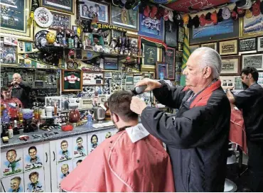  ?? Picture: Thapelo Morebudi ?? Bennie Botes attends to Patrick Maloney in his barber shop packed with rugby memorabili­a.