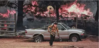  ?? Kent Porter / Press Democrat via Associated Press ?? The Ranch Fire jumps out ahead of the main wildfire, burning two homes in Spring Valley, Calif., as firefighte­rs battle to stop the spread of the massive blaze in Lake County.