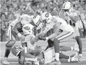  ?? Charlie Riedel / Associated Press ?? Titans receiver Eric Decker, center, is congratula­ted by teammates after snaring a go-ahead 22yard touchdown catch against Chiefs defensive back Eric Murray late in the game Saturday.