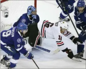  ?? THE ASSOCIATED PRESS ?? The Chicago Blackhawks’ Marcus Kruger (16) is pushed down in front of the Tampa Bay Lightning net in the second period of Game 2 Saturday.