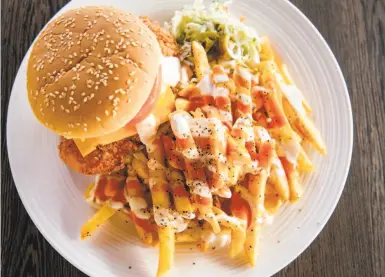  ?? Photos by Brittany Hosea- Small / Special to The Chronicle ?? The spicy crispy chicken sandwich and fries at Mirchi Cafe in Dublin shows off the cuisine’s cultural fusion.