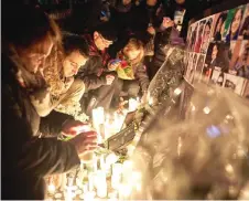  ?? — AFP photo ?? File photo shows mourners lighting candles for the victims of Ukrainian Airlines flight 752 which crashed in Iran during a vigil at Mel Lastman Square in Toronto, Ontario.