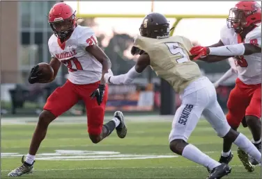  ??  ?? Maumelle wide receiver Roderick Watts (left) carries the ball past Joe T. Robinson defender Jaden Bush (5) in the first quarter of the Hornets’ 28-20 loss to the Senators.
(Arkansas Democrat-Gazette/Justin Cunningham)