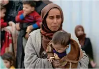  ??  ?? MISERY MOUNTS: Syrians from the rebel-held Eastern Ghouta cross a regime-controlled corridor in Hamouria, after leaving the besieged enclave towards government areas on Friday. — AFP