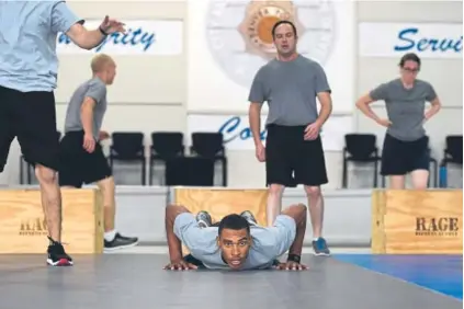  ?? Photos by Joe Amon, The Denver Post ?? Justis Nelson, center, joins other recruits in taking part in a high-intensity training session at the Denver Police Department’s academy last week.