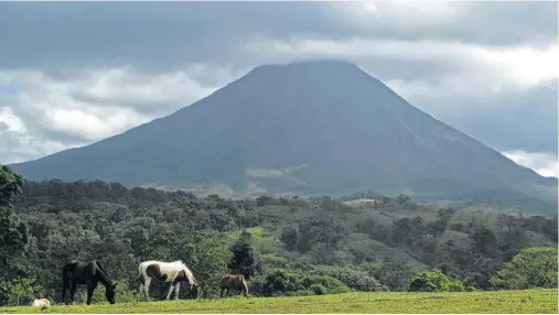  ?? Terri Colby / Tribune News Service ?? The Arenal Volcano, perhaps one of Costa Rica’s most notable topographi­cal features, is surrounded by a national park and is near rural tourism sites as well as spots for zip lining, whitewater rafting and soaking in the hot springs.