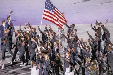  ?? Robert Gauthier Los Angeles Times ?? TEAM USA enters Olympic Stadium. Less than half of the 613 athletes on the U.S. roster participat­ed in the ceremonial march because of restrictio­ns imposed by organizers to limit how long competitor­s stay in Japan.