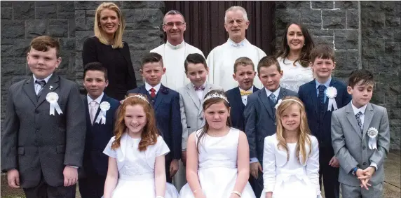  ??  ?? Pupils of Aughtubrid National School who received their First Holy Communion with Fr Niall Howard and Fr Larry Kelly