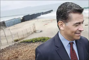  ?? Francine Orr Los Angeles Times ?? ATTY. GEN. Xavier Becerra stands near a border fence in San Diego County. He and 19 other attorneys general are legally challengin­g the president’s emergency declaratio­n that seeks money to expand the border wall.