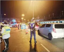  ?? ?? A police photo shows personnel manning the roadblock at Jalan Tabuan.