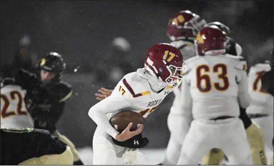  ?? RJ SANGOSTI — THE DENVER POST ?? Rocky Mountain High School quarterbac­k Gage Brook (17) runs the ball down field against Mountain Vista High School during their Class 5A state playoff game at Halftime Help Stadium on Thursday night in Highlands Ranch.