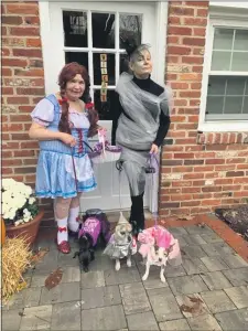  ?? SUBMITTED PHOTO ?? Heading off for some trick-or-treating fun last year, coordinate­d in “The Wizard of Oz”-themed costumes, are Florence Lauria, 94, dressed as Dorothy, her daughter Annette Reyman, right, dressed as the Wicked Witch of the West, and their three dogs dressed as Toto, the Tin Man and Glinda the Good Witch.