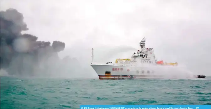  ??  ?? AT SEA: Chinese firefighti­ng vessel ‘DONGHAIJIU 117’ sprays water on the burning oil tanker Sanchi at sea off the coast of eastern China. — AFP