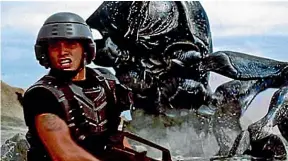  ?? ?? Paul Verhoeven’s Starship Troopers matched pin-up acting talent against gruesome insects from outer space – and created a wonderful weaponised Baywatch.