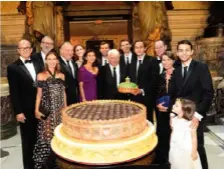  ??  ?? The entire Cassegrain clan gathers around an enormous birthday cake that required four people to carry up the staircase