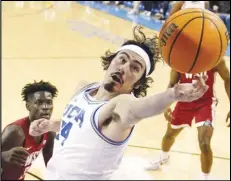  ?? Associated Press ?? UCLA guard Jaime Jaquez Jr. (right) reaches for a rebound as Washington State forward Mouhamed Gueye watches during the first half on Feb. 4 in Los Angeles. Jaquez was named The Associated Press player of the year in the Pac-12 Conference on Tuesday.