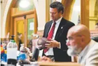  ??  ?? Rep. Justin Everett holds a football during a vote at the state Capitol on Wednesday The final day of this session of the General Assembly is May 9.