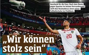  ??  ?? Geschenk für die Fans: Nach dem Remis gegen Spanien im letzten Vorrundens­piel wirf Aziz Bouhaddouz einen seiner Fußballsch­uhe ins Publikum.