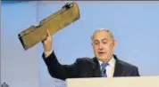  ?? TWITTER ?? Prime Minister Benjamin Netanyahu, speaking at the Munich Security Conference, holds up a remanent of what he said was an Iranian drone, warning Tehran to not test “Israel’s resolve”.