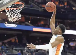  ??  ?? Tennessee guard Admiral Schofield (5) goes in for a dunk against Colgate in the first round of the NCAA Tournament. BRIANNA PACIORKA/NEWS SENTINEL