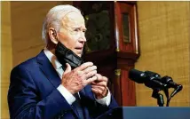  ?? ANDREW HARNIK/ASSOCIATED PRESS ?? President Joe Biden removes his mask to speak from the Treaty Room in the White House on Wednesday about pulling the remainder of U.S. troops from Afghanista­n.