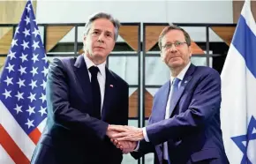  ?? EVELYN HOCKSTEIN/POOL VIA AP ?? Secretary of State Antony Blinken, left, meets with Israeli President Isaac Herzog in Tel Aviv Tuesday. Blinken said he made it clear that Palestinia­ns “must not be pressed to leave Gaza” after the war.