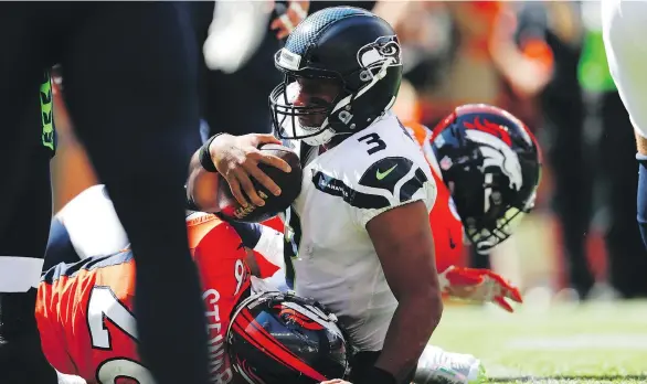  ?? THE ASSOCIATED PRESS FILES ?? Seahawks quarterbac­k Russell Wilson has been sacked 12 times in two games this season, first feeling the pressure from Denver in Week 1, then Chicago on Monday.